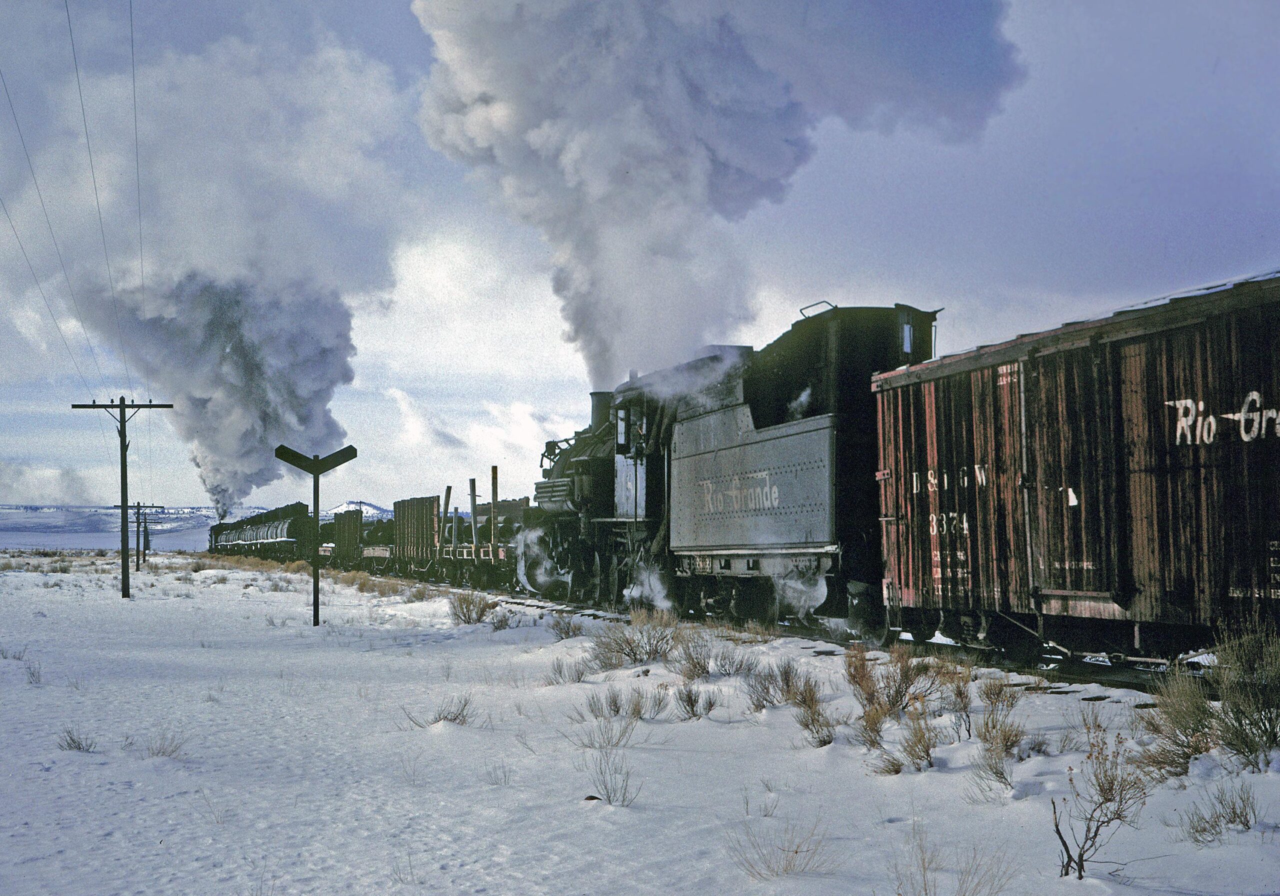 D&RGW #480 is the mid-train helper on a freight heading west for Cumbres from Antonito.  A flanger-spreader train is clearing the line ahead of them.