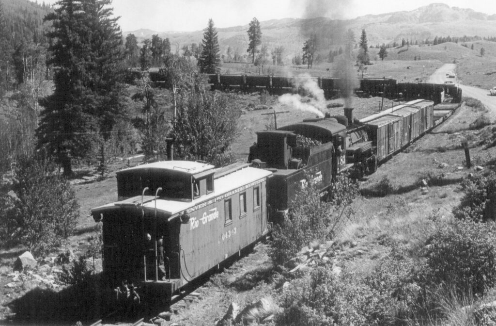 Old B&W image of K-36 #483 pushing a long freight