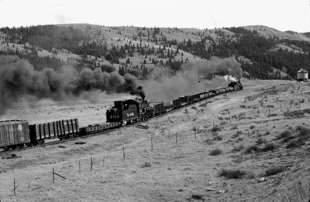 Old image of K-36 #483 helping out a long train at Los Pinos