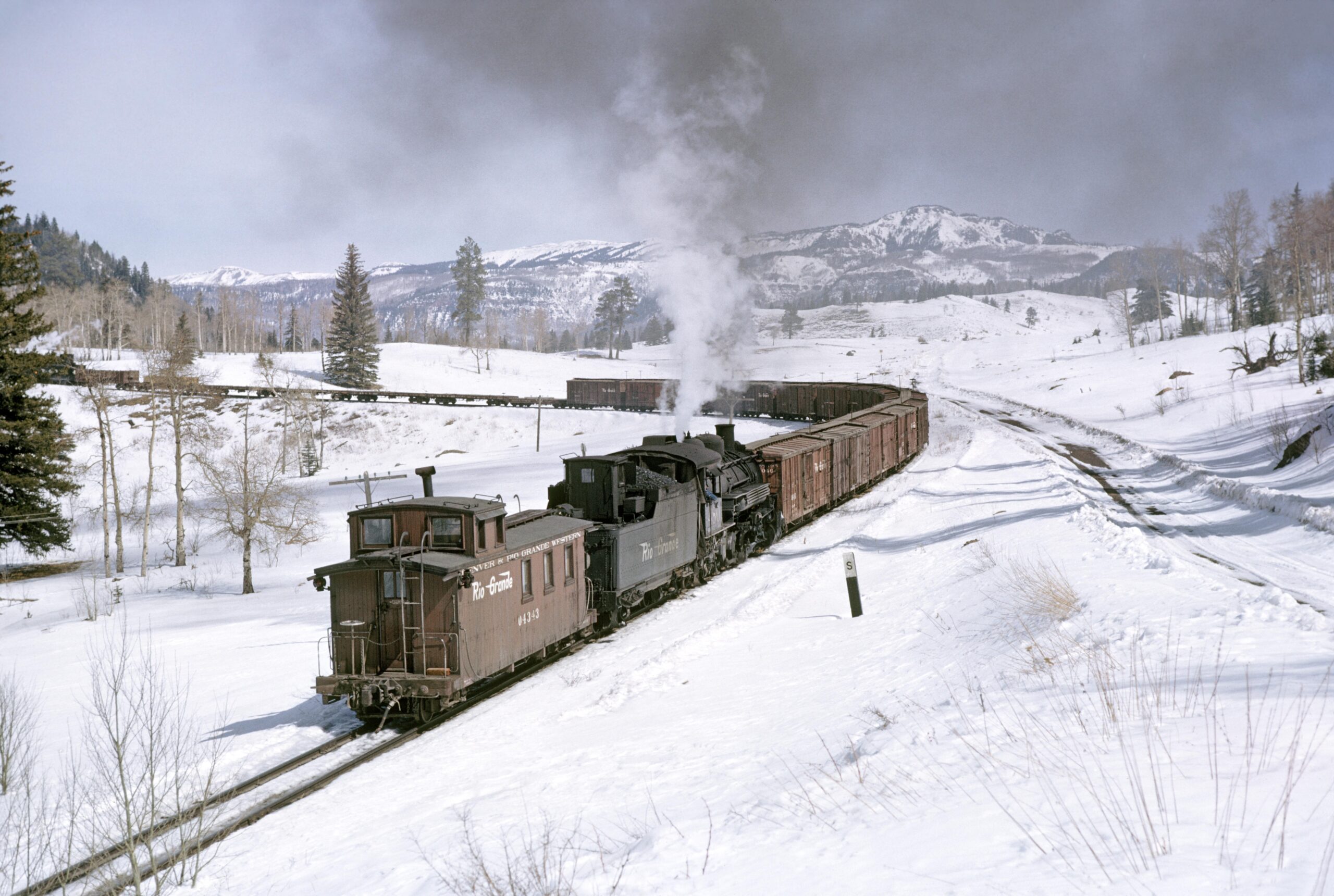 3/4 RR view of D&RGW #480 as pusher on east bound freight with caboose #04343 nearing Lobato.